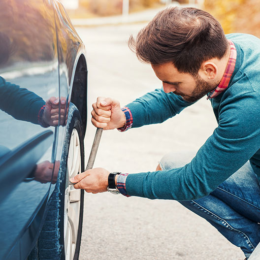 man fixing flat tire